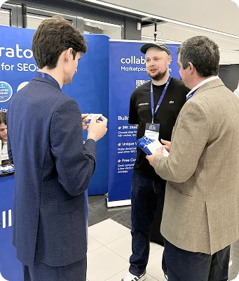 Representante de Collaborator hablando con un asistente en SERP Conf. Sofia 2026.